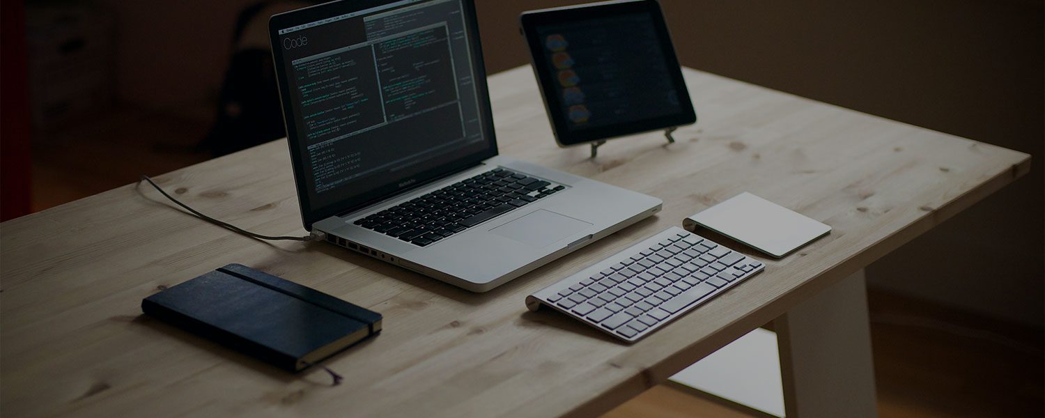 Developer workstation with code displayed across multiple screens