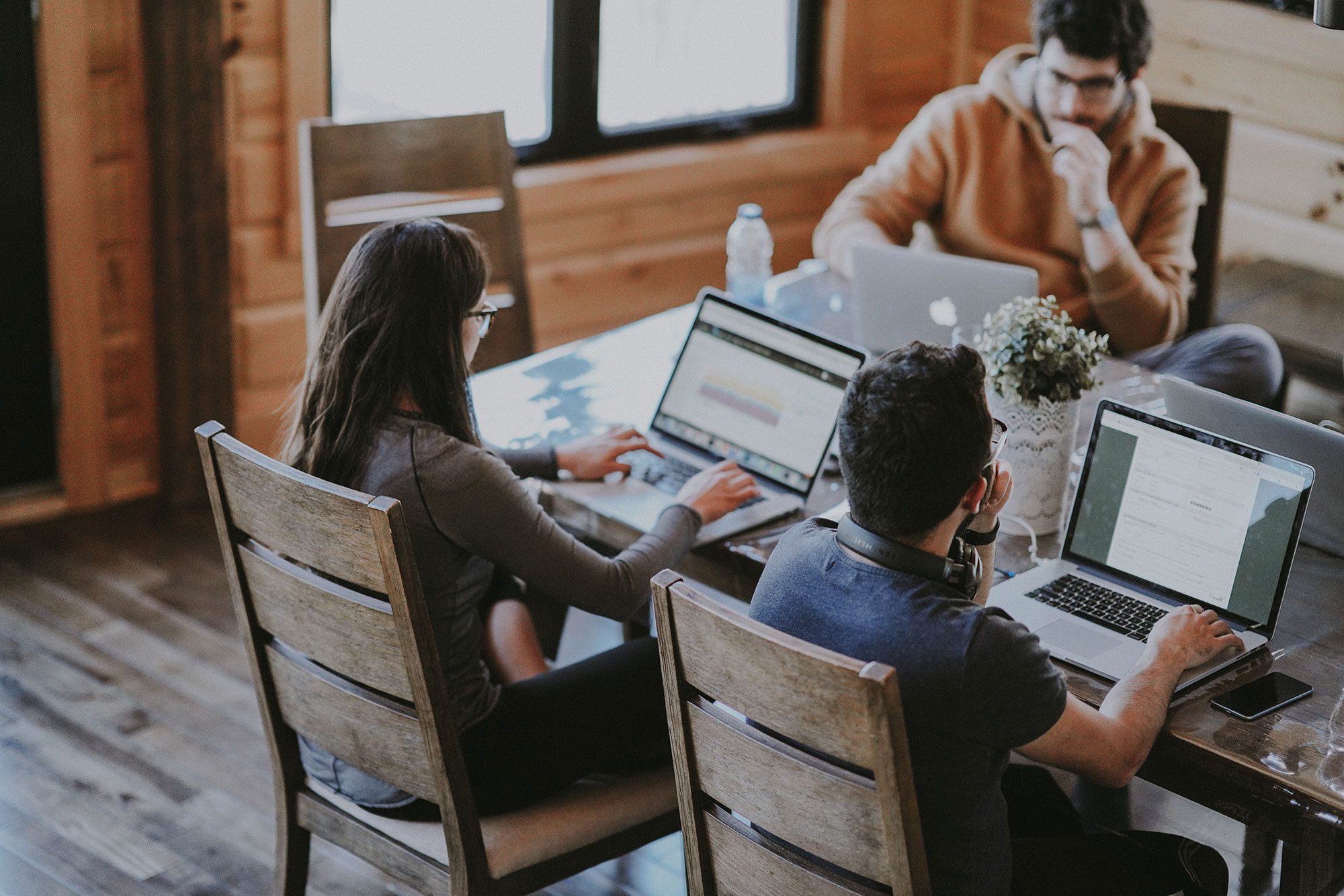 Agency team working together at a shared desk on client campaigns